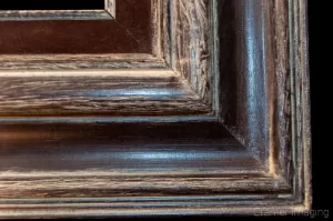 Cramer Imaging's photograph of a single ornate wooden picture frame corner on a black background