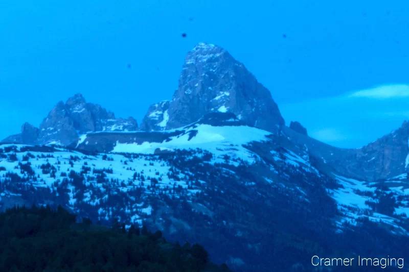 Photograph of mountains at blue hour demonstrating the need to regularly clean your camera sensor because of dust