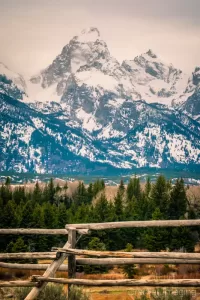 Fine art landscape photograph of a rustic wooden fence against the Grand Teton of Grand Teton National Park Wyoming by Cramer Imaging