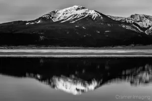 Cramer Imaging's black and white or monochrome fine art landscape photograph of a mountain reflecting in a calm lake