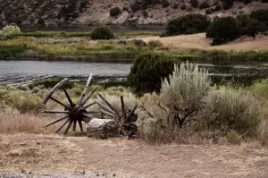 Cramer Imaging's professional quality natural scenic landscape photograph of wagon wheels, axle, and sagebrush on the Snake River at Massacre Rocks, Idaho