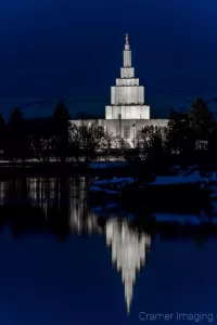 Cramer Imaging's fine art photograph of the Idaho Falls LDS Temple at twilight in winter with Snake River reflection