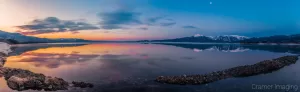 Cramer Imaging's professional quality landscape panorama photograph of the sky and moon reflecting in Henry's Lake at dawn with blue and golden hours