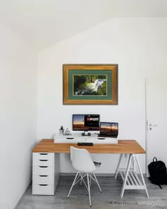 Photograph of Cramer Imaging's fine art photograph 'Upper Mesa Falls' on the wall of a room with a desk and computer