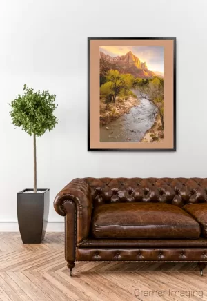 Cramer Imaging's fine art photograph "Zion's National Park" staged in a living room space with a leather couch