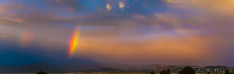 Cramer Imaging's fine art landscape photograph of a double rainbow arc against a dramatic sunset sky in Panguitch, Utah