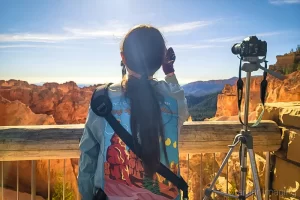 Professional photographer Audrey Cramer taking pictures at Bryce Canyon's Natural Bridge for the 2023 annular "ring of fire" eclipse