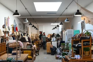 Photograph of a man in a thrift store or second-hand store