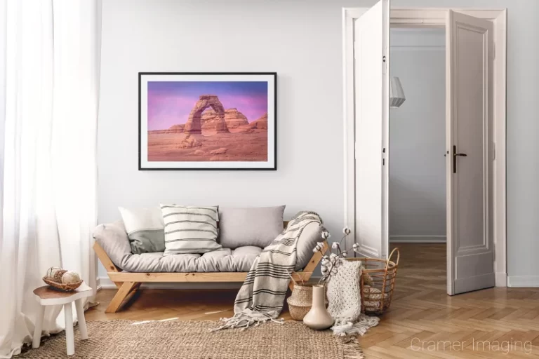 Photograph of Cramer Imaging's landscape photo "Delicate Arch Sunset" in a cozy neutral-toned living room