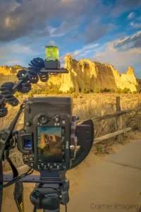 Cramer Imaging's photograph of a camera on a tripod taking a Grosvenor Arch in Escalante National Monument, Utah