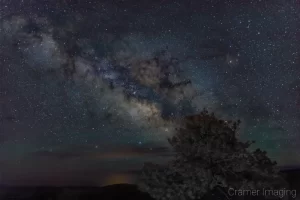 Cramer Imaging's fine art landscape photograph of the Milky Way rising over Bryce Canyon National Park Utah and aligning with a tree