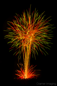 Cramer Imaging's fine art photograph of bright fireworks in the sky and ground-show fireworks in Panguitch, Utah